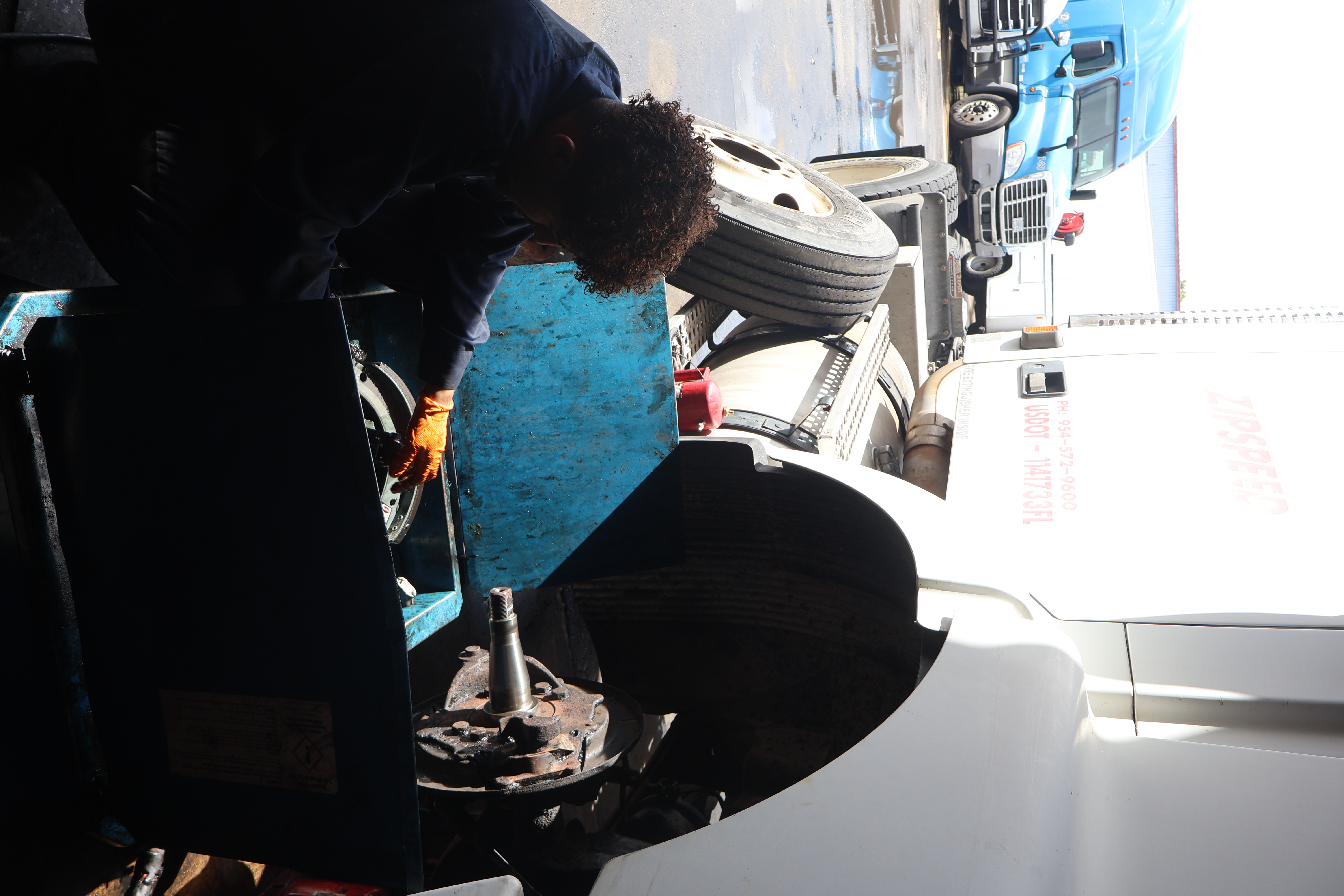 Mechanic performing precision bearing work on truck axle